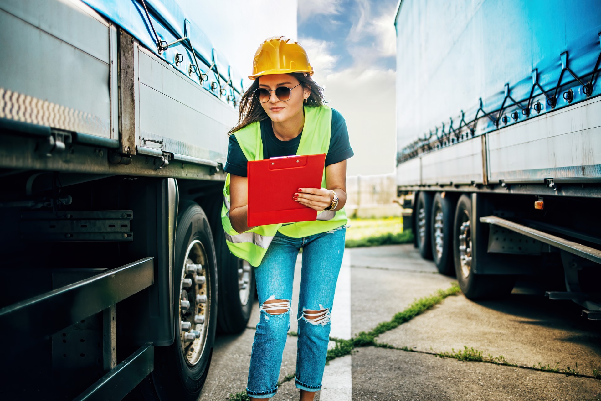 Professional female truck driver inspecting a vehicle